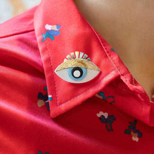 Pin's Oeil magique blanc et doré
