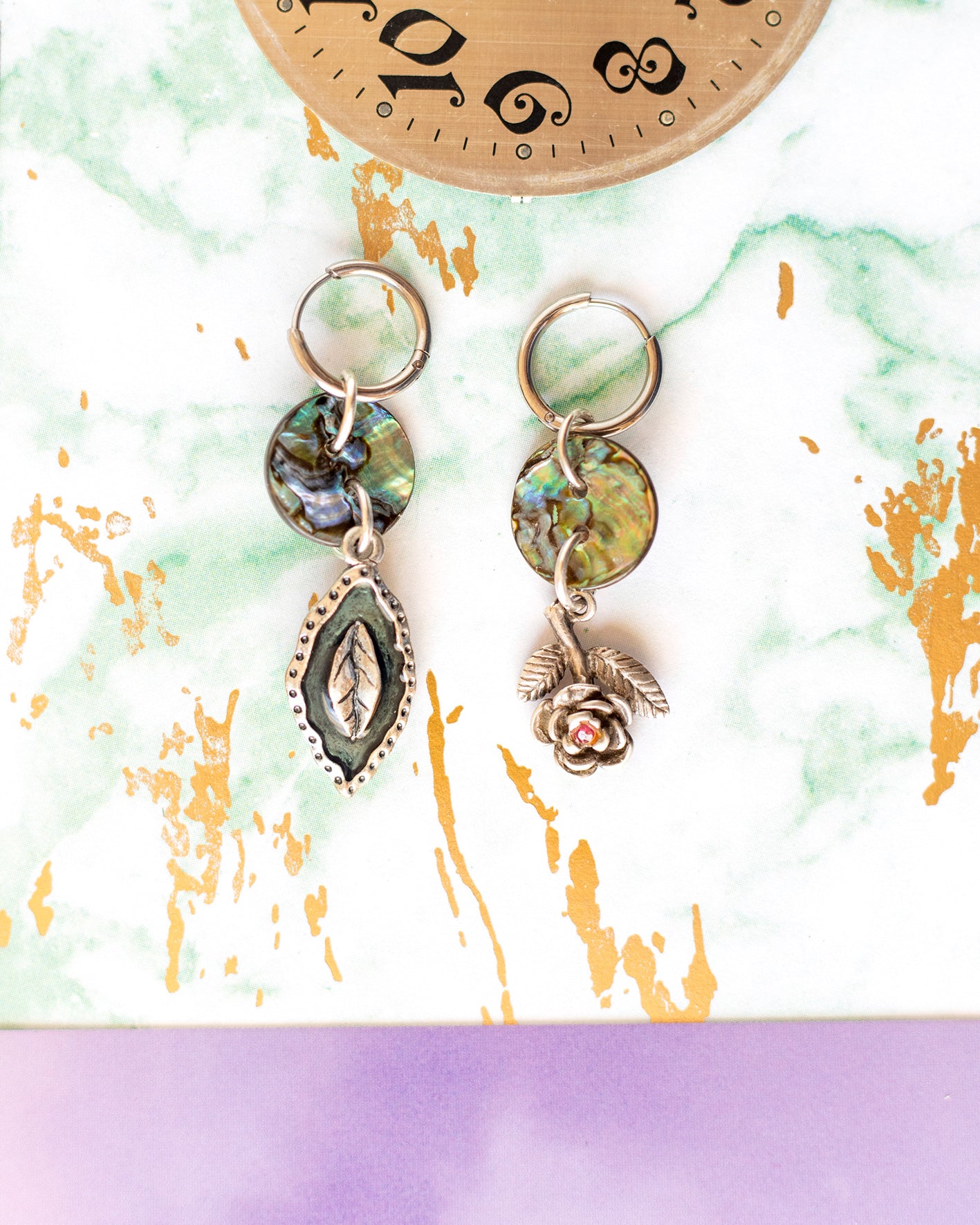 Steel hoop earrings and abalone mother-of-pearl buttons