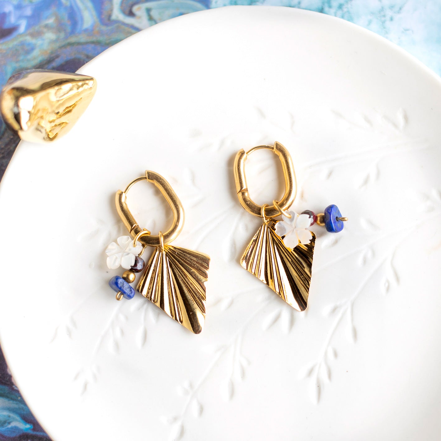 Steel hoop earrings and gold-plated brass pendants