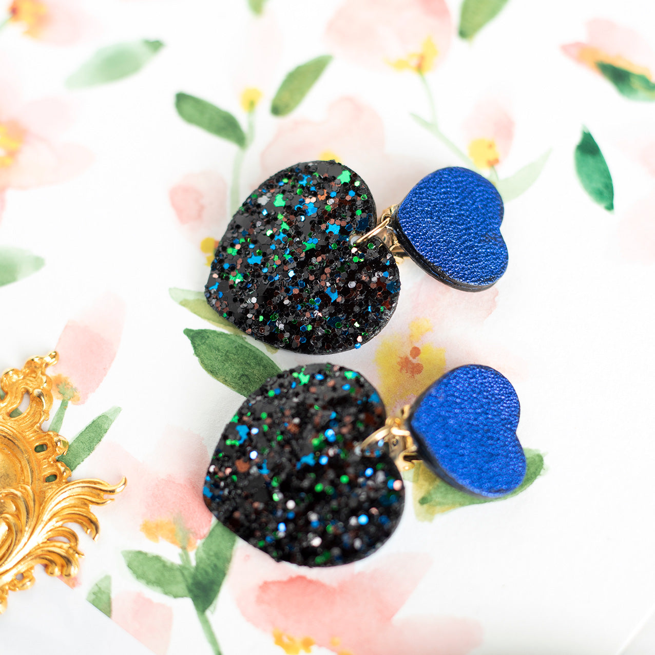 Double Hearts clip-on earrings - metallic blue leather and black sequins