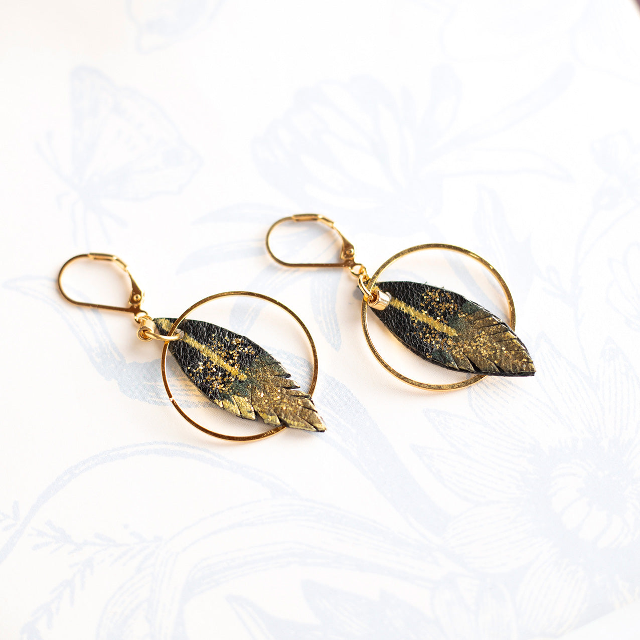 Feather hoop earrings in black and gold leather