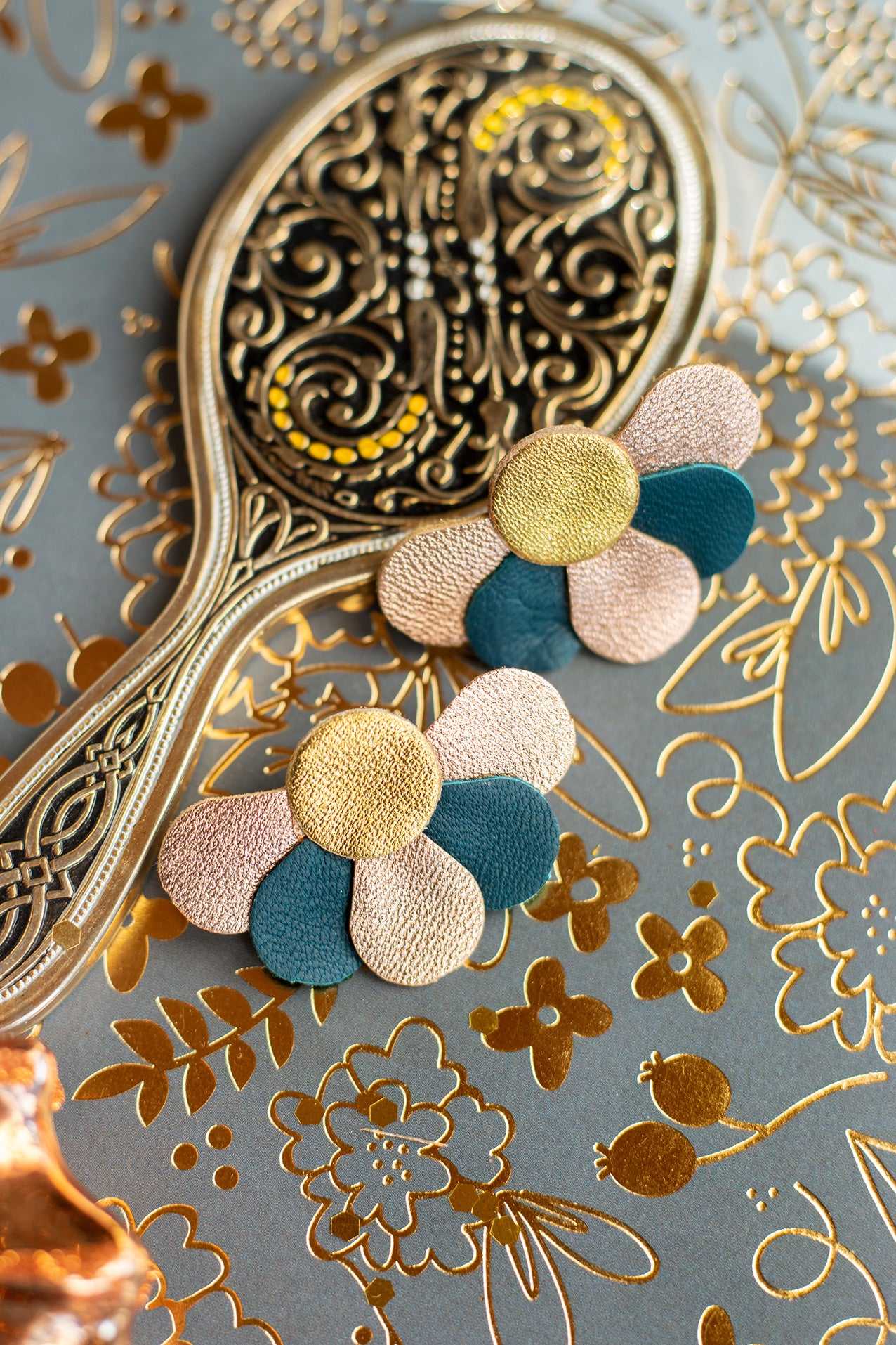Dark blue-green and gold flower stud earrings