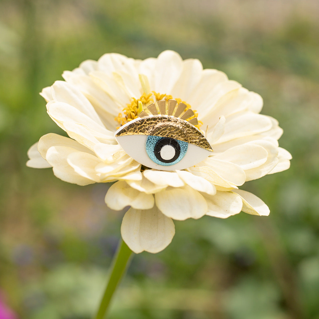 White and gold magic eye pin