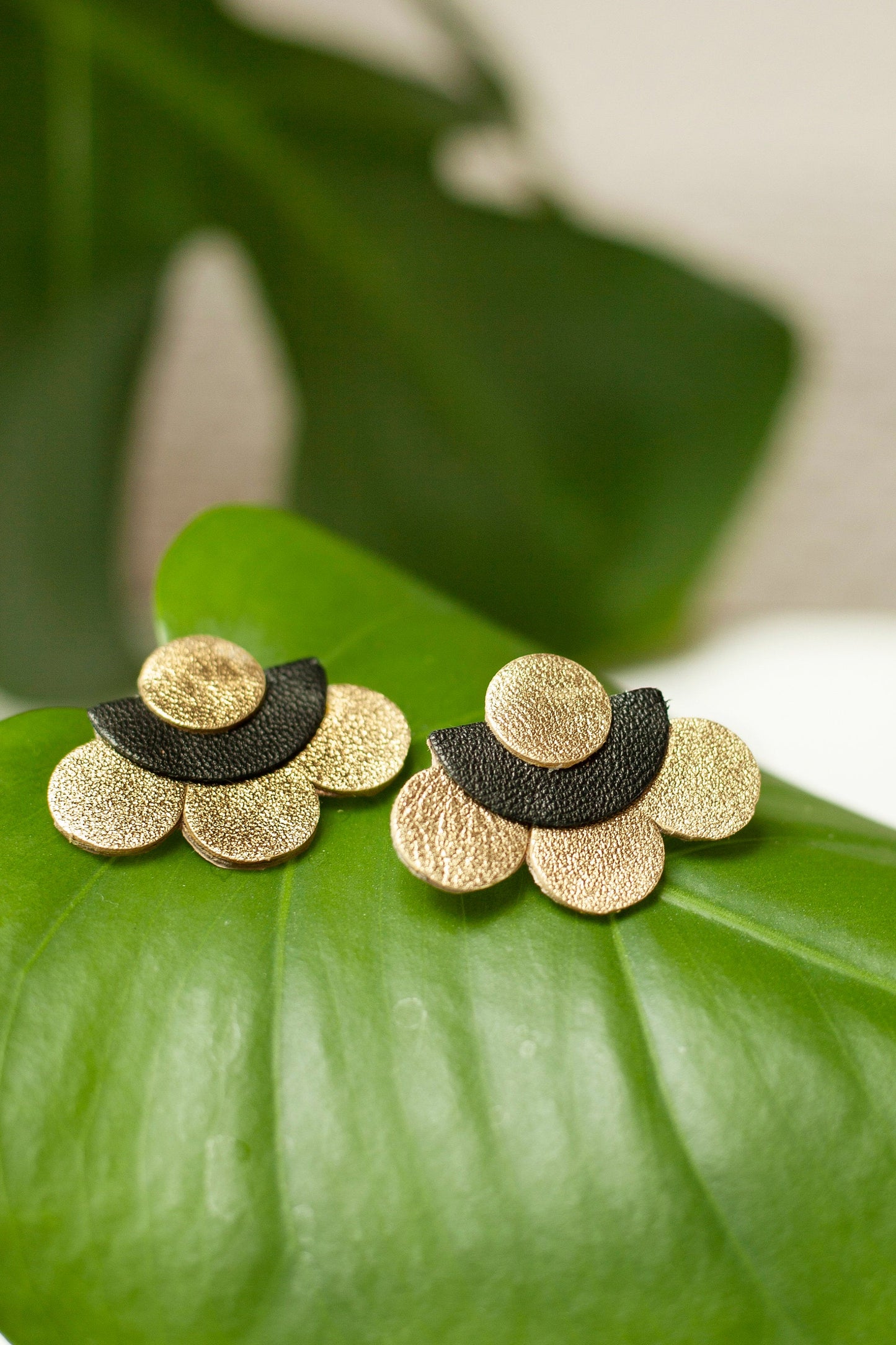 Gold and black leather flower stud earrings