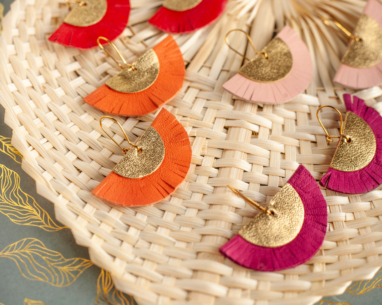 Half-circle fringed earrings in orange and gold leather